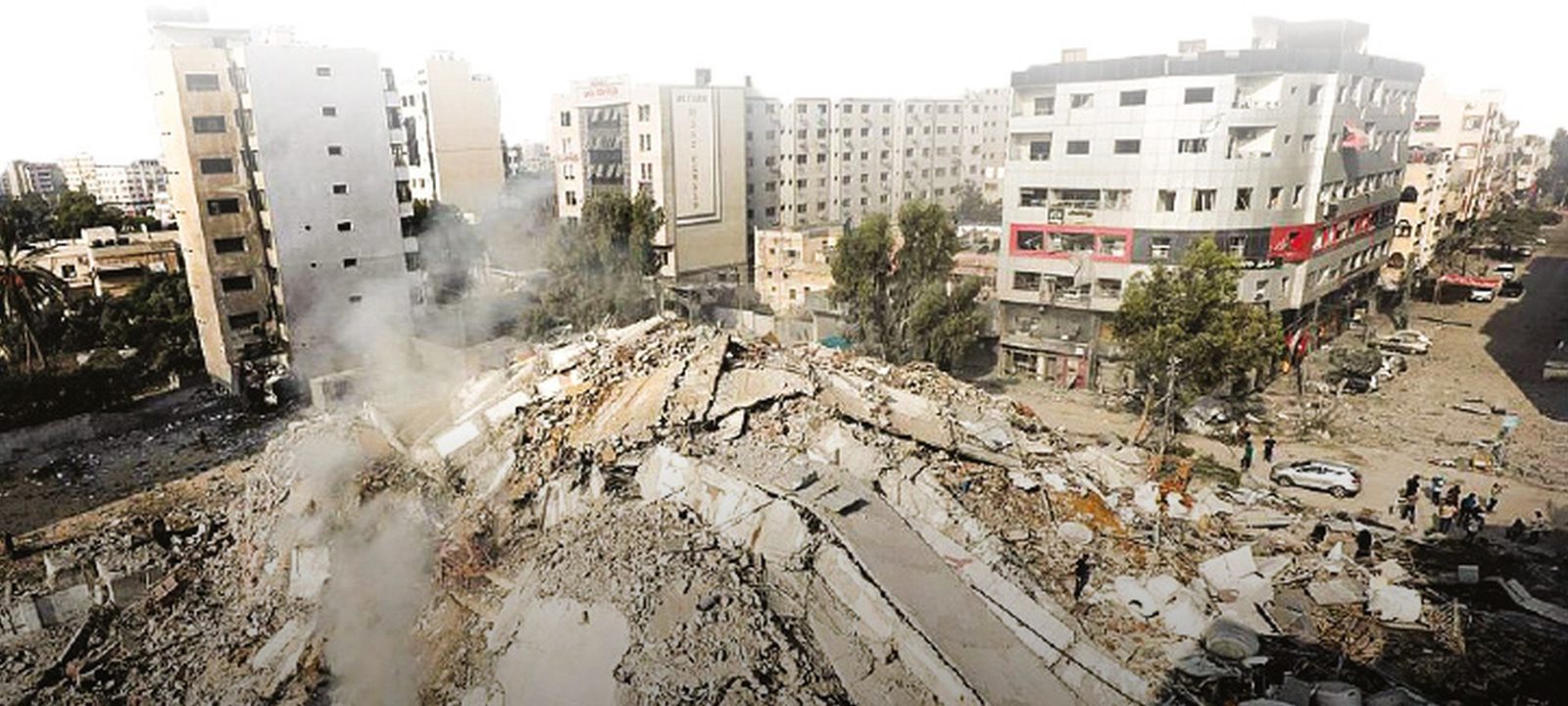 Collapsed and damaged buildings in Gaza, with rubble filling the street